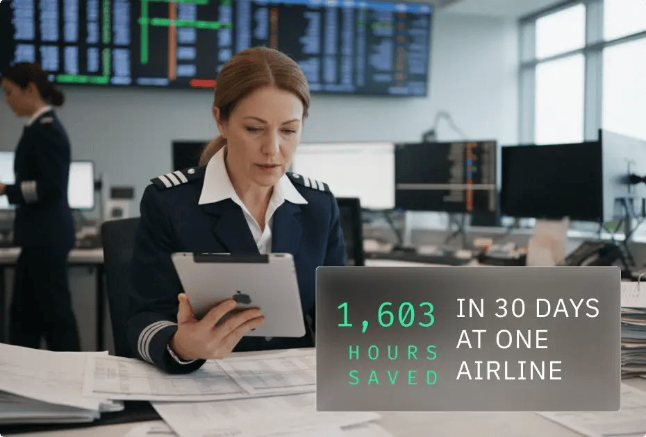 A pilot sits at a desk with a tablet, surrounded by computer screens displaying flight data and statistics about saved hours.