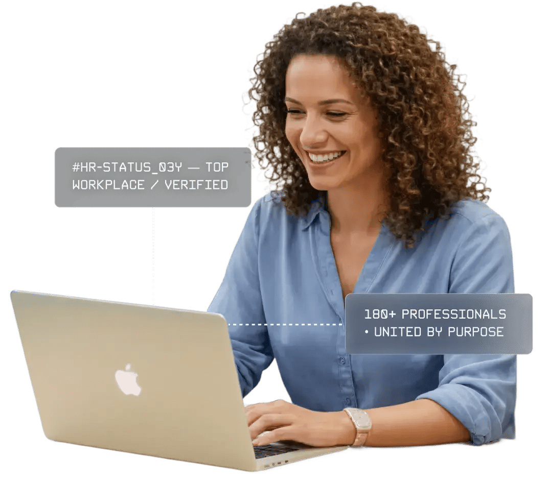 A person with curly hair sits at a laptop, showcasing a "Top Workplace" badge and stating "180+ professionals united by purpose."
