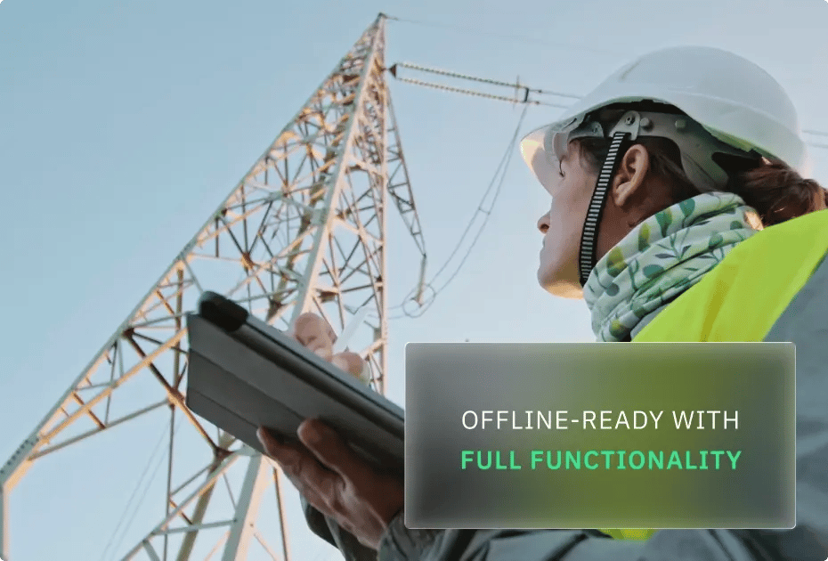 Worker with tablet near power lines, emphasizing offline readiness.