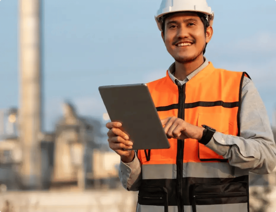 Man in safety gear review data on device.
