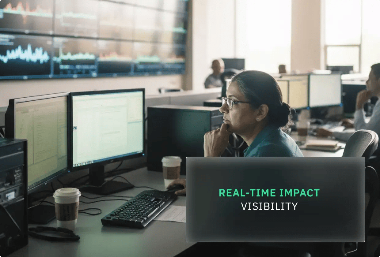Woman analyzing data at a trading desk with multiple screens.