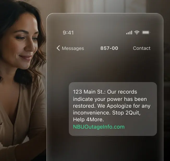 A woman looks at her phone as a message notification appears on screen, showing a power restoration alert with an address and outage information link