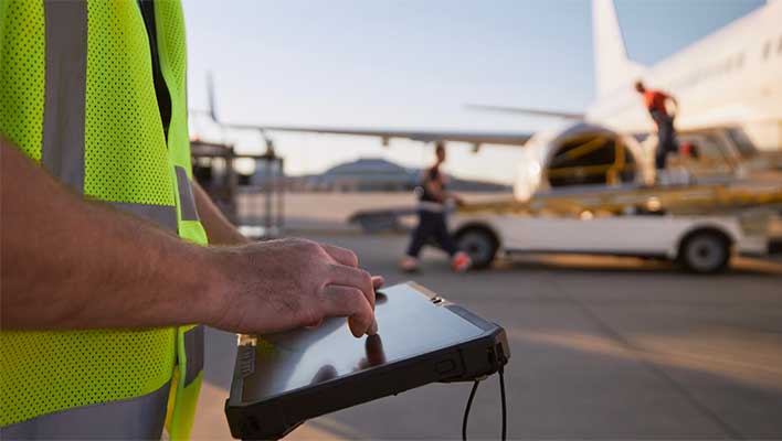 An airline utility worker using ARCOS's Ascend to initiate automated callouts