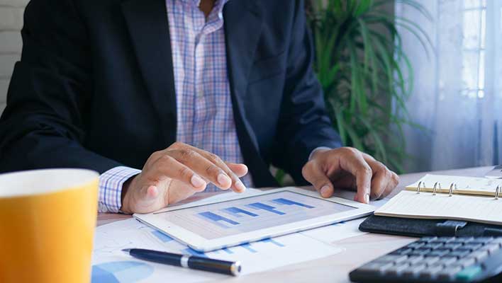 Business man interacting with a graph on a tablet