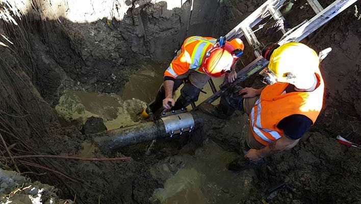 Water utility workers fixing a broken water main