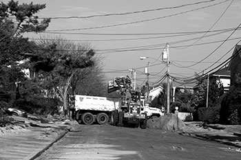 Crews clean up a residential street during hurricane season