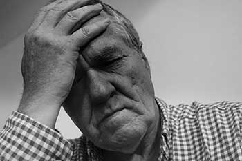 Frustrated businessman with hand on forehead