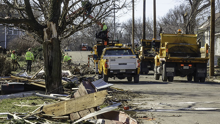 Utility crew cleaning up debris from a storm