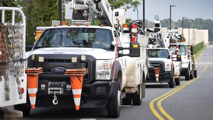 Utility trucks traveling in convoy