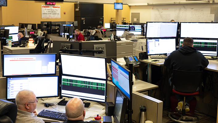 Call center with several desks holding multiple computer monitors