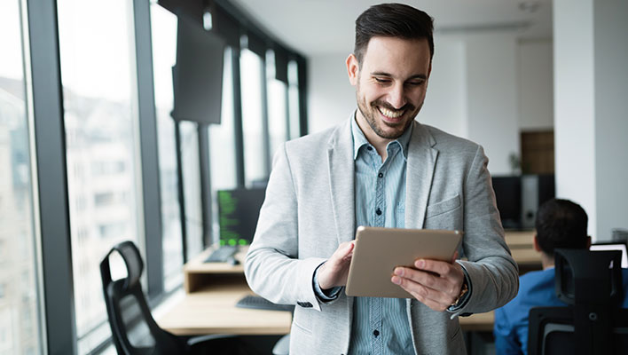 An office utility worker looking excited about the efficiency and lack of paper work thanks to ARCOS's utility management software