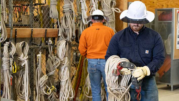 Utility workers preparing rope for belays