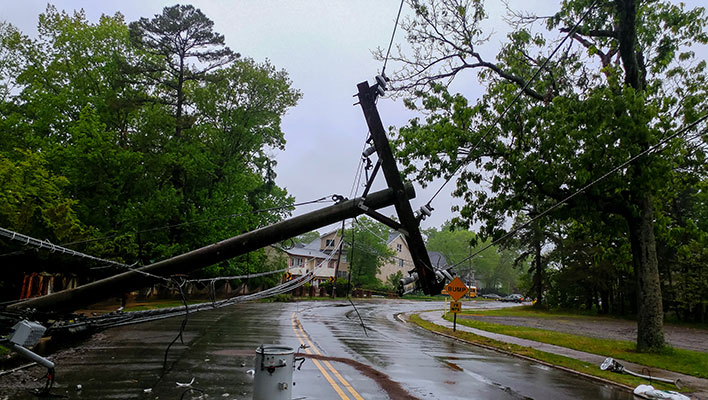 A power line collapsed in the street after a storm