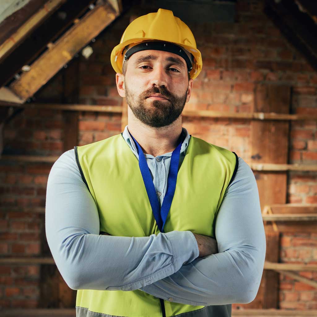 An electrical worker facing camera, arms crossed