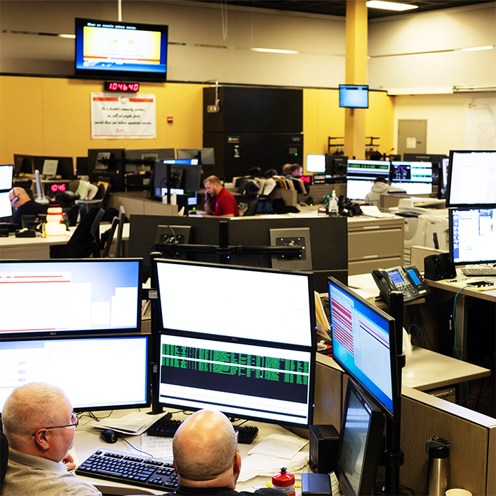 Call center with several desks holding multiple computer monitors