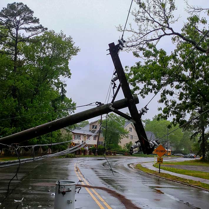 A power line collapsed in the street after a storm