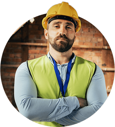 A construction worker standing in a brick room