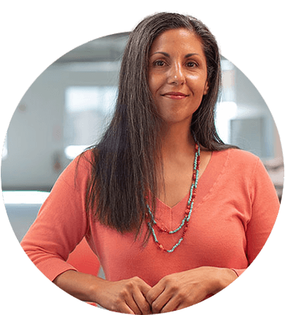 Businesswoman looking at the camera while leaning against a table