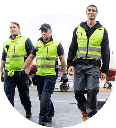 Three airline utility workers walking together